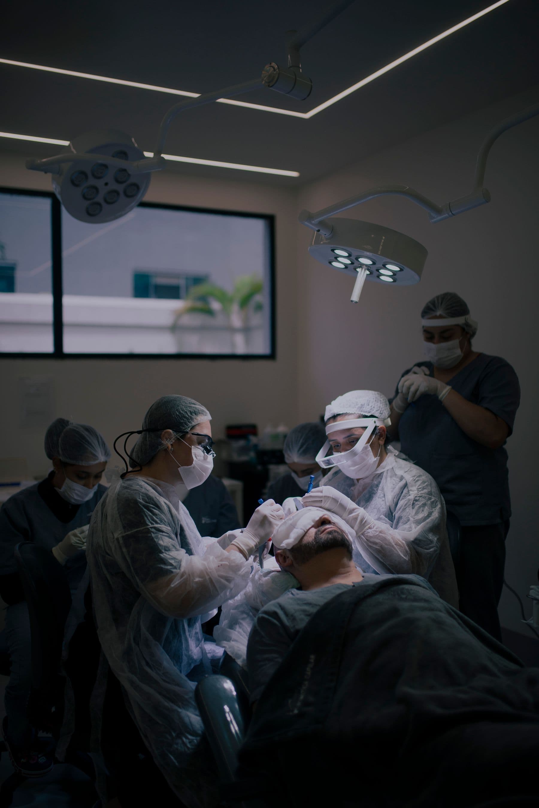 A surgical team performing a hair transplant in an operating room